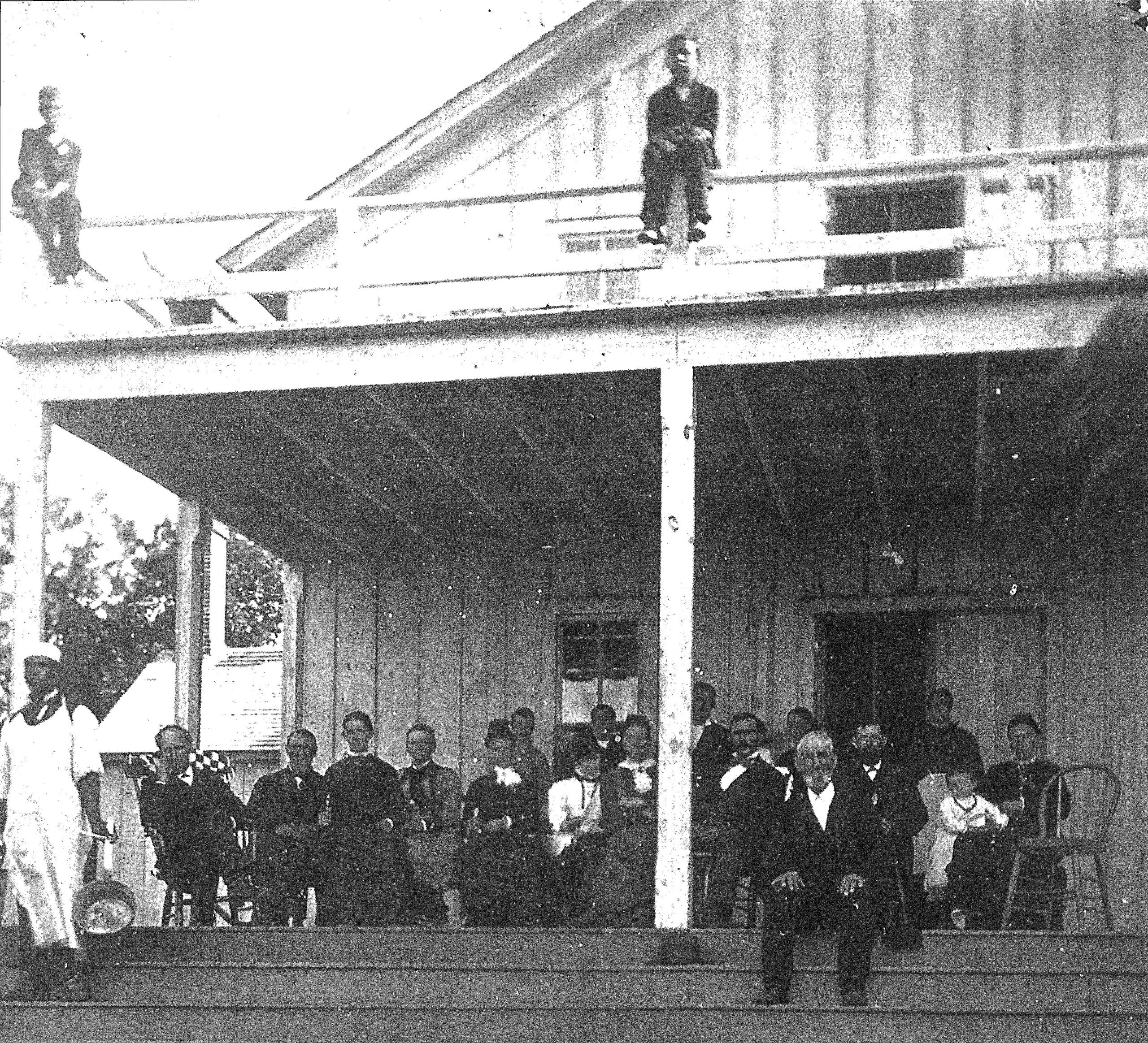 people on steps of Island House hotel